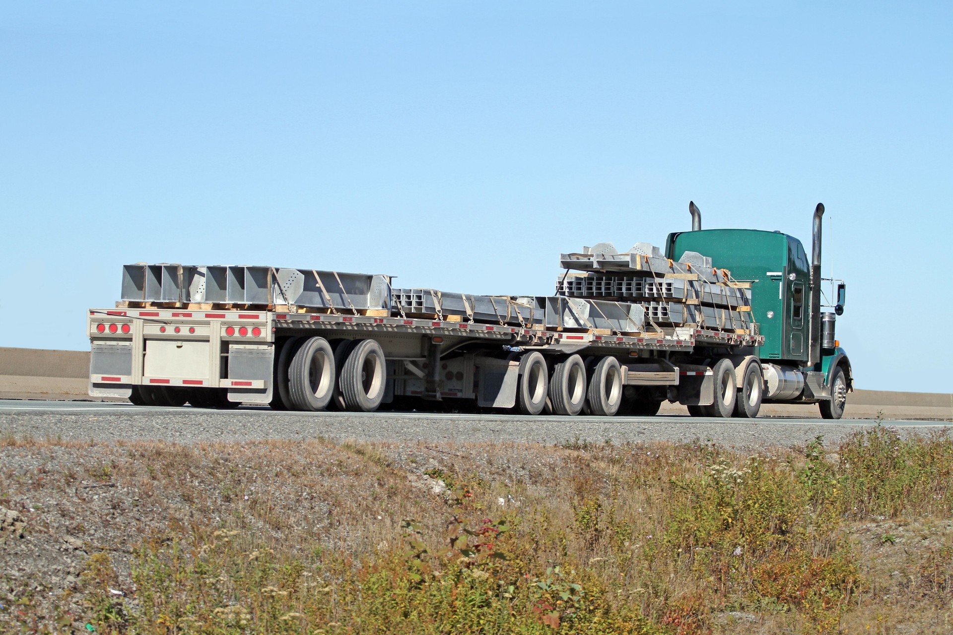 Semi Flatbed Truck Hauling Steel Girders On Interstate Highway
