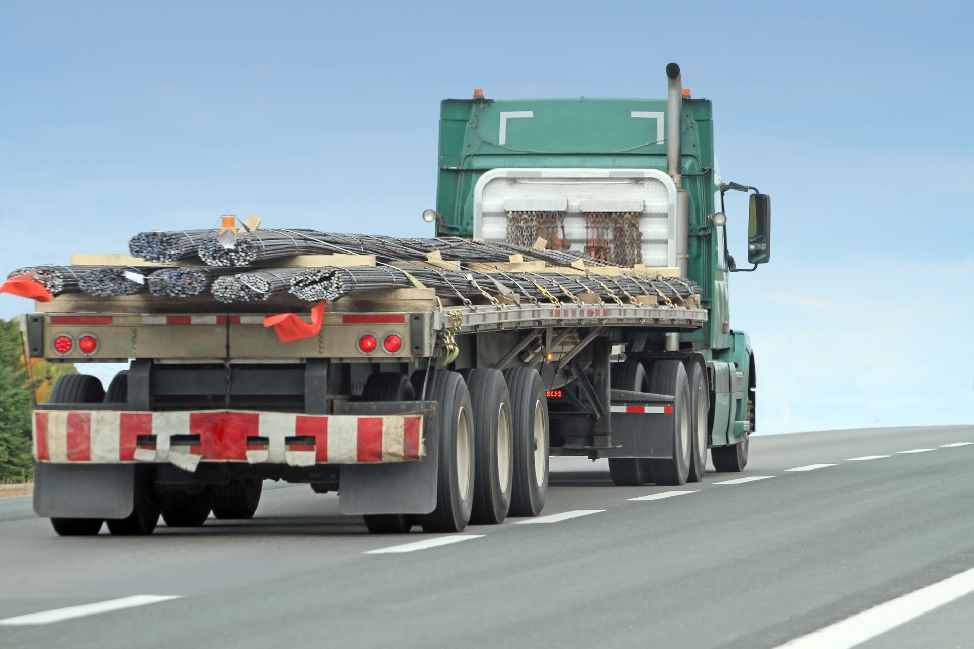 Semi Flatbed Truck Hauling Rebar To A Construction Site
